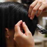 Hair stylist performing precision haircut